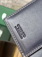 Goyard leather pouch corner with embossed lettering and contrast stitching