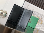 Black leather wallet interior with card slots and central divider, open view
