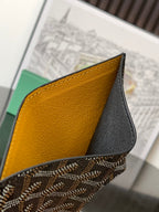 Two-tone leather wallet panel with yellow interior and black exterior, stitched edge