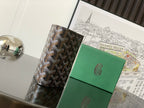 Wallet with geometric canvas front and black leather edge trim, front view