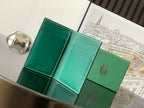 Green small bag opened to show inner card slots and teal leather lining.