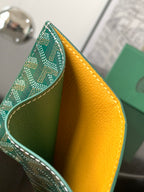 Small bag side view: green patterned exterior with yellow interior lining.