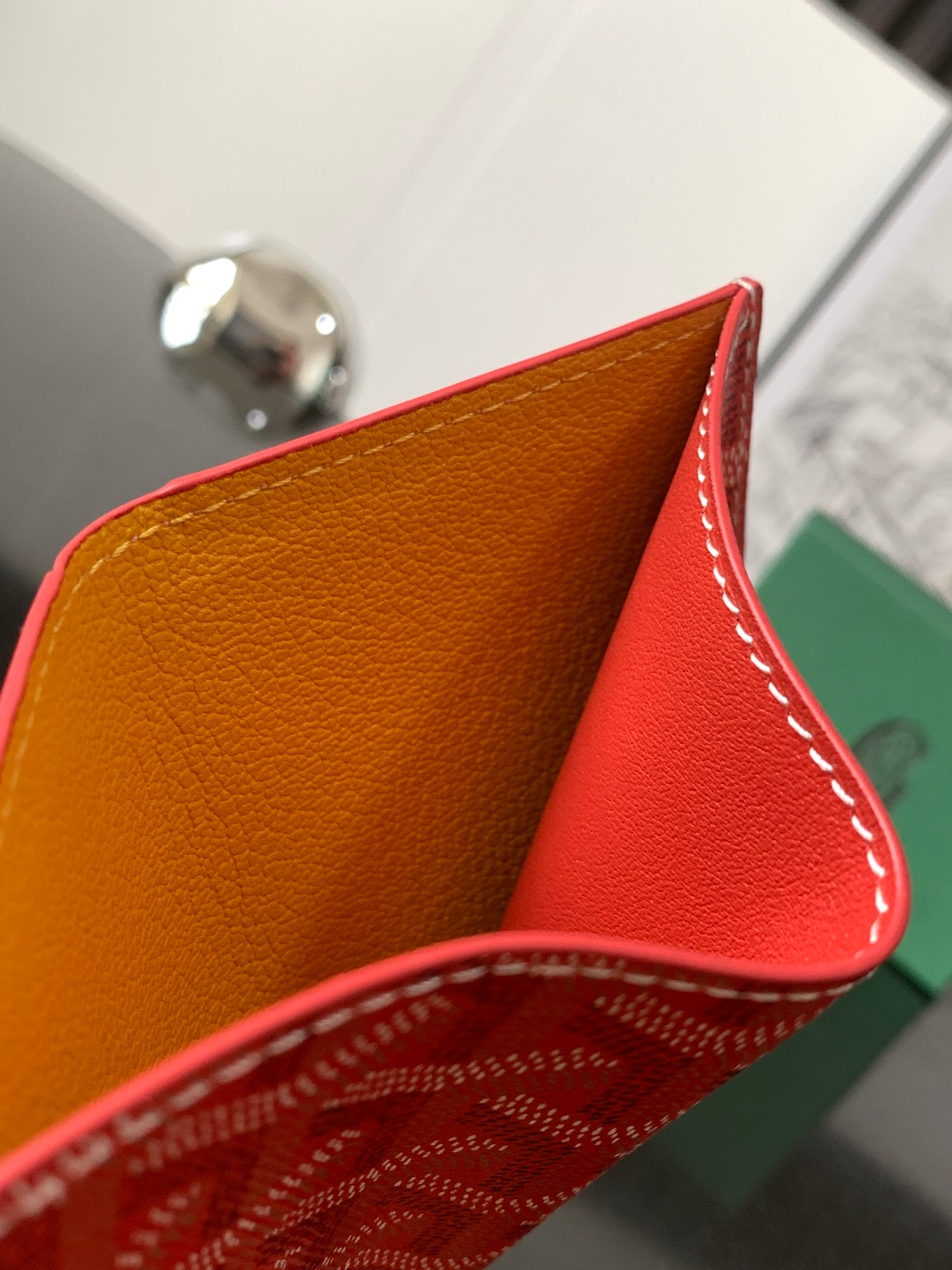 Goyard wallet interior with tan lining and red leather edge with white stitching