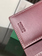 Maroon leather small bag with stitched edge and Goyard logo embossing