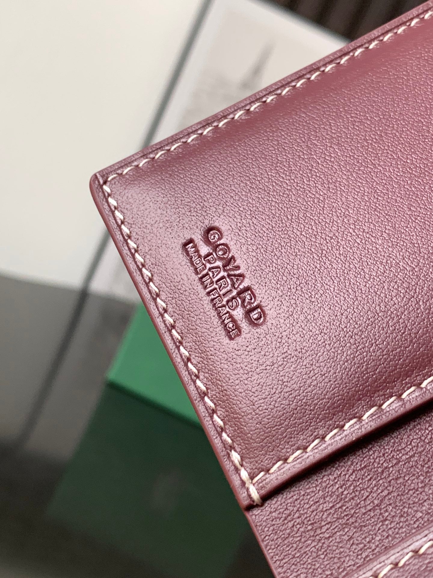 Maroon leather small bag with stitched edge and Goyard logo embossing