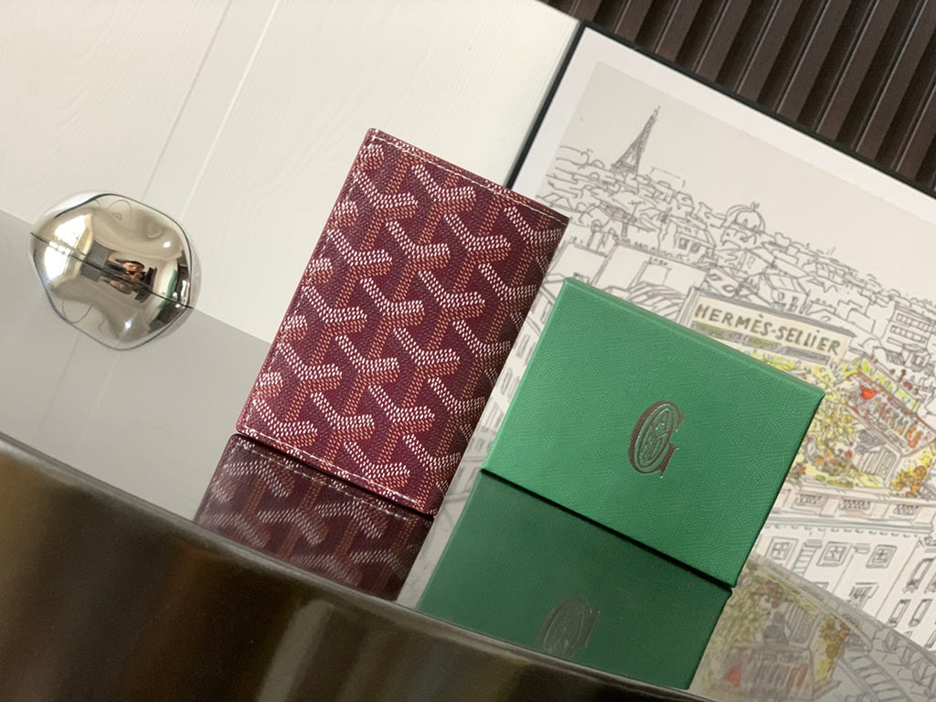 Burgundy patterned Goyard small bag, angled view with logo