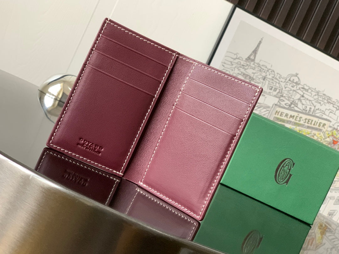 Goyard bag interior with maroon leather panels and stitched edges
