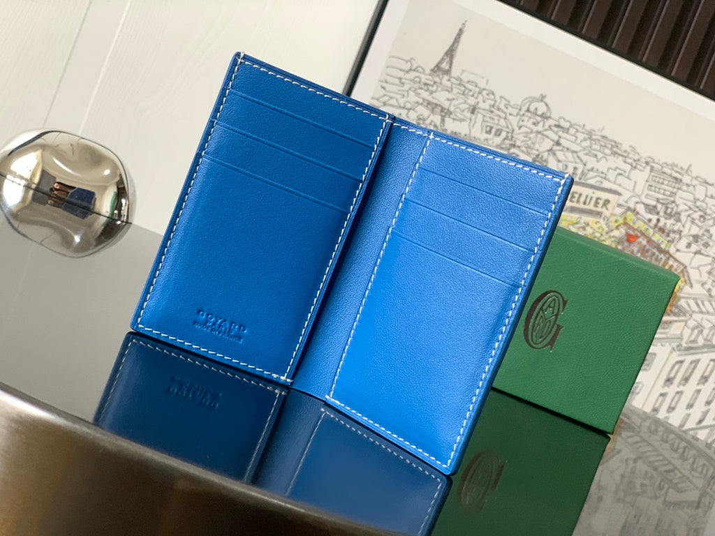 Goyard small bag open with blue leather compartments and stitched edges