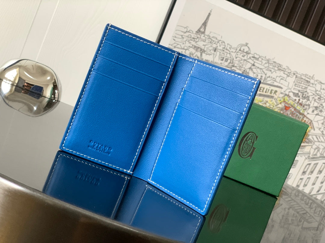 Goyard blue leather wallet opened to card slots, stitched seams