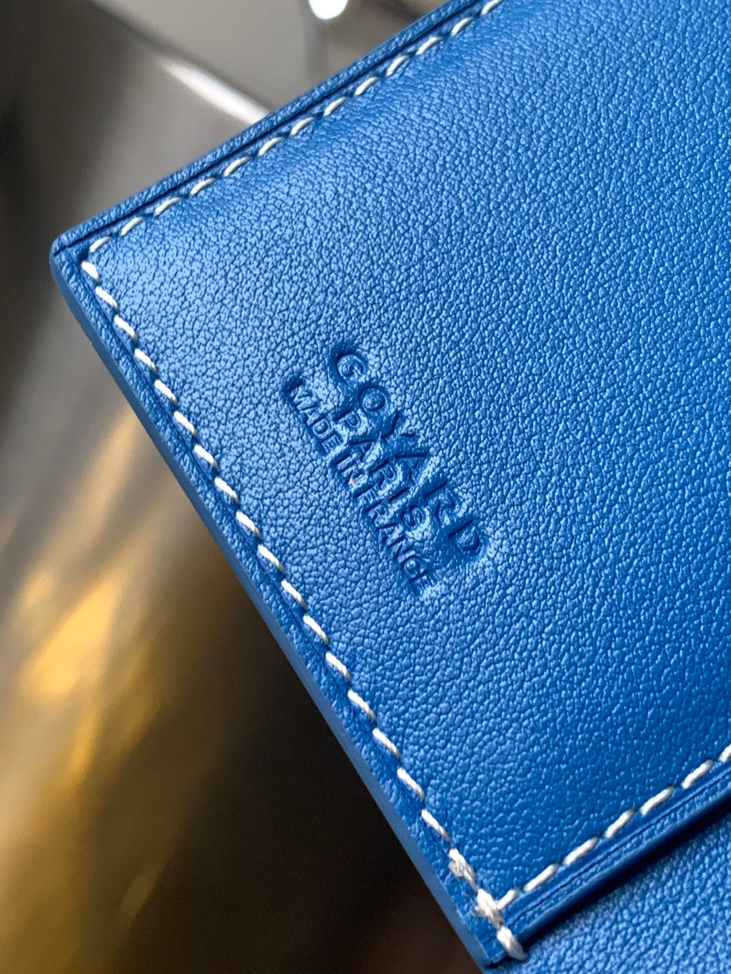 Goyard blue leather card holder corner with embossed logo and white stitching