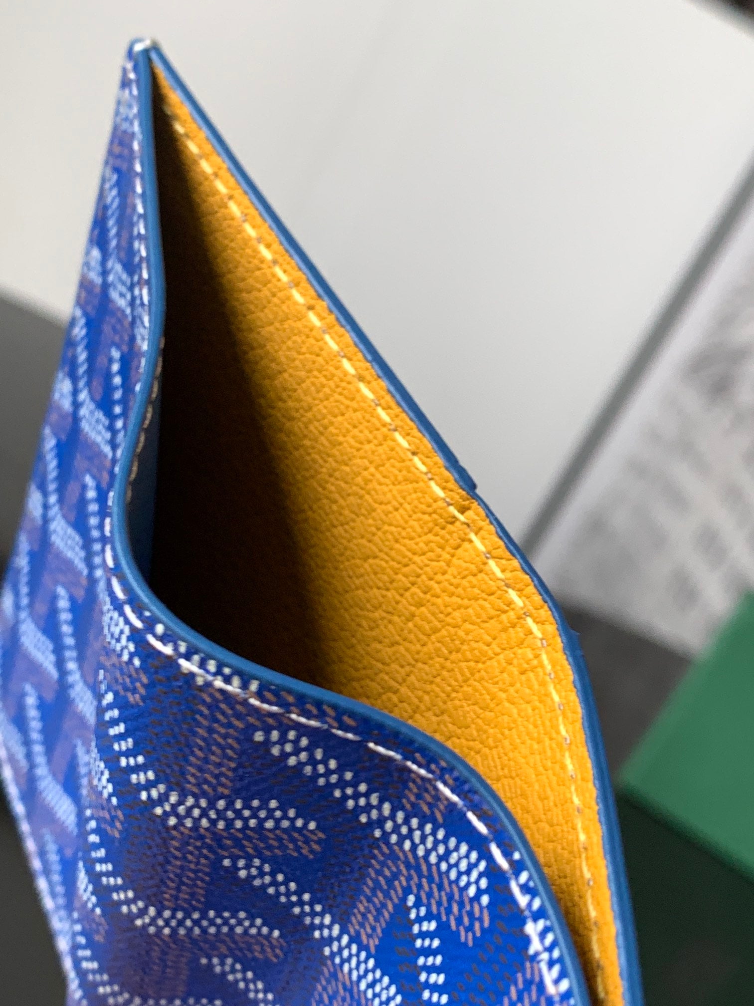 Goyard small bag with blue patterned exterior and yellow interior lining