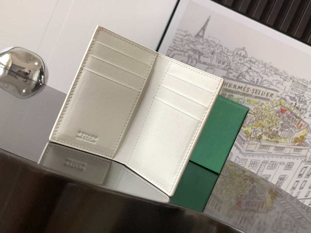 Small bag open to white interior compartments with green outer backing