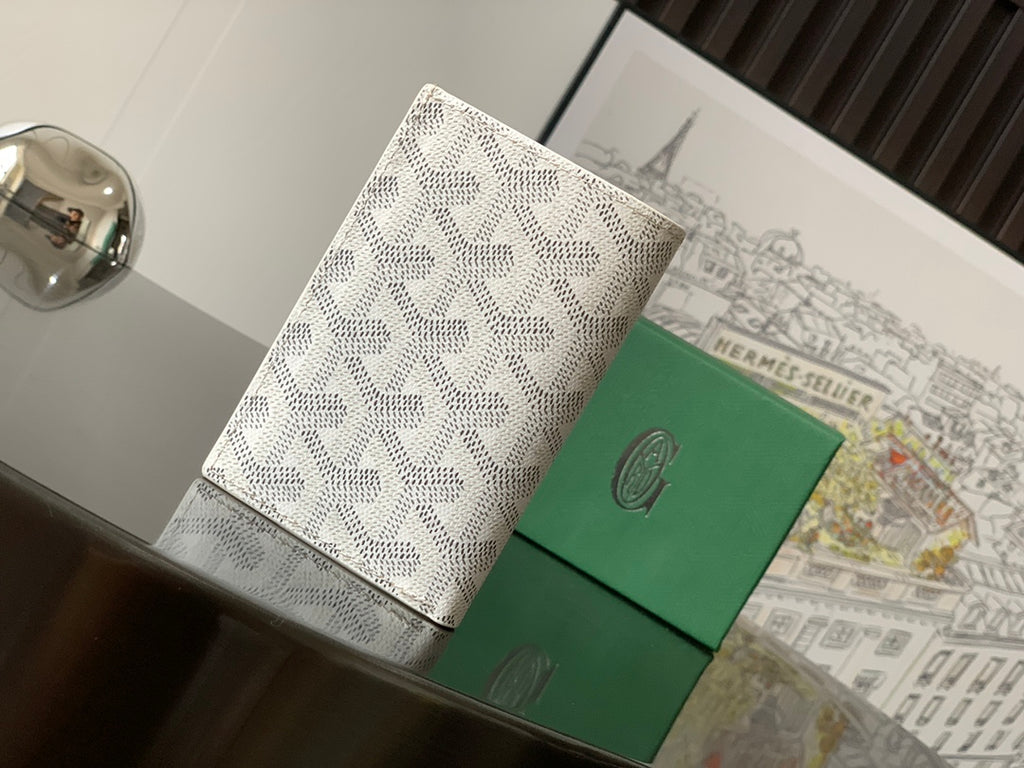 Small bag with white monogram pattern and green front panels, front view