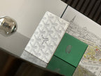 Goyard bag with white monogram canvas and green leather panels