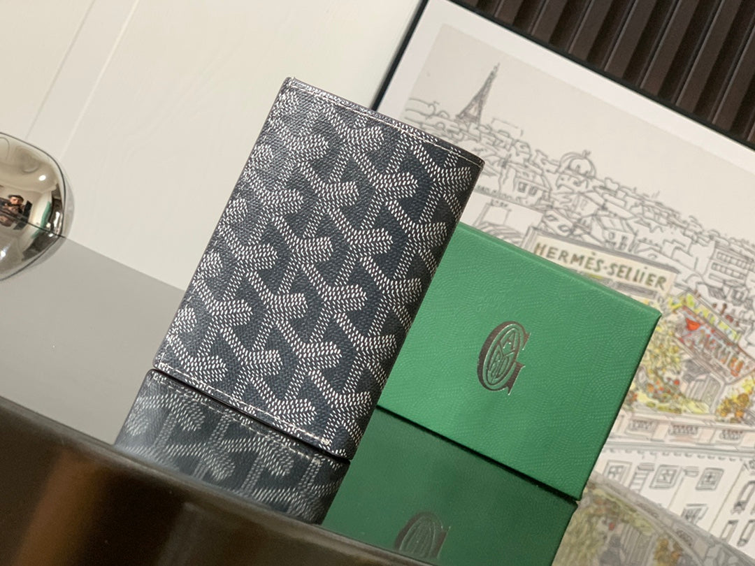Goyard monogram wallet with stitched border and signature pattern.
