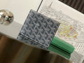 Goyard small bag with dark patterned canvas and leather trim, front flap closure