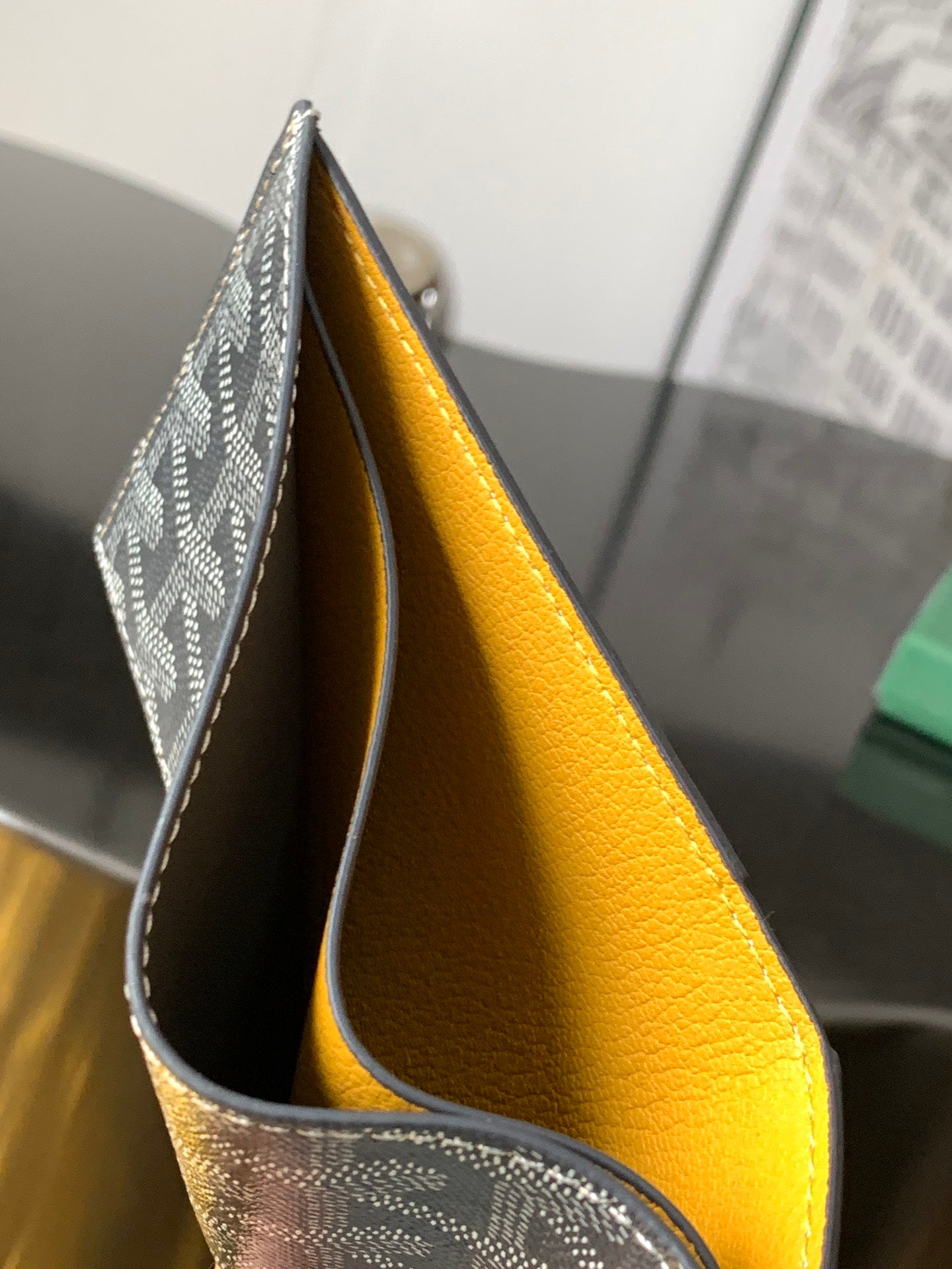 Goyard bag open view showing bright yellow leather lining and patterned exterior