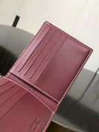 Burgundy small bag front view with card slots and visible stitched detailing.