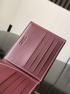 Burgundy leather card holder showing four card slots and logo stamp