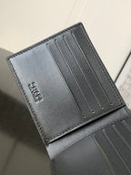 Small bag interior card slots in dark gray leather with gold-toned pins