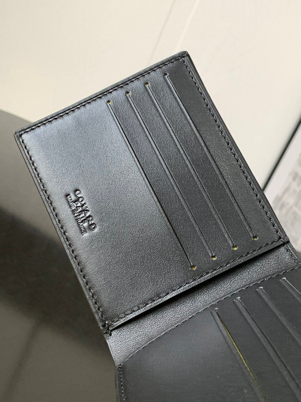 Leather card holder interior with multiple card slots and stitched edges