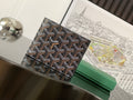 Small bag with dark patterned canvas front and clasp flap