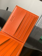 Orange Goyard card holder wallet with front panel and 5 vertical card slots.