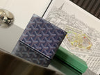 Small bag with navy geometric pattern exterior and stitched dark trim