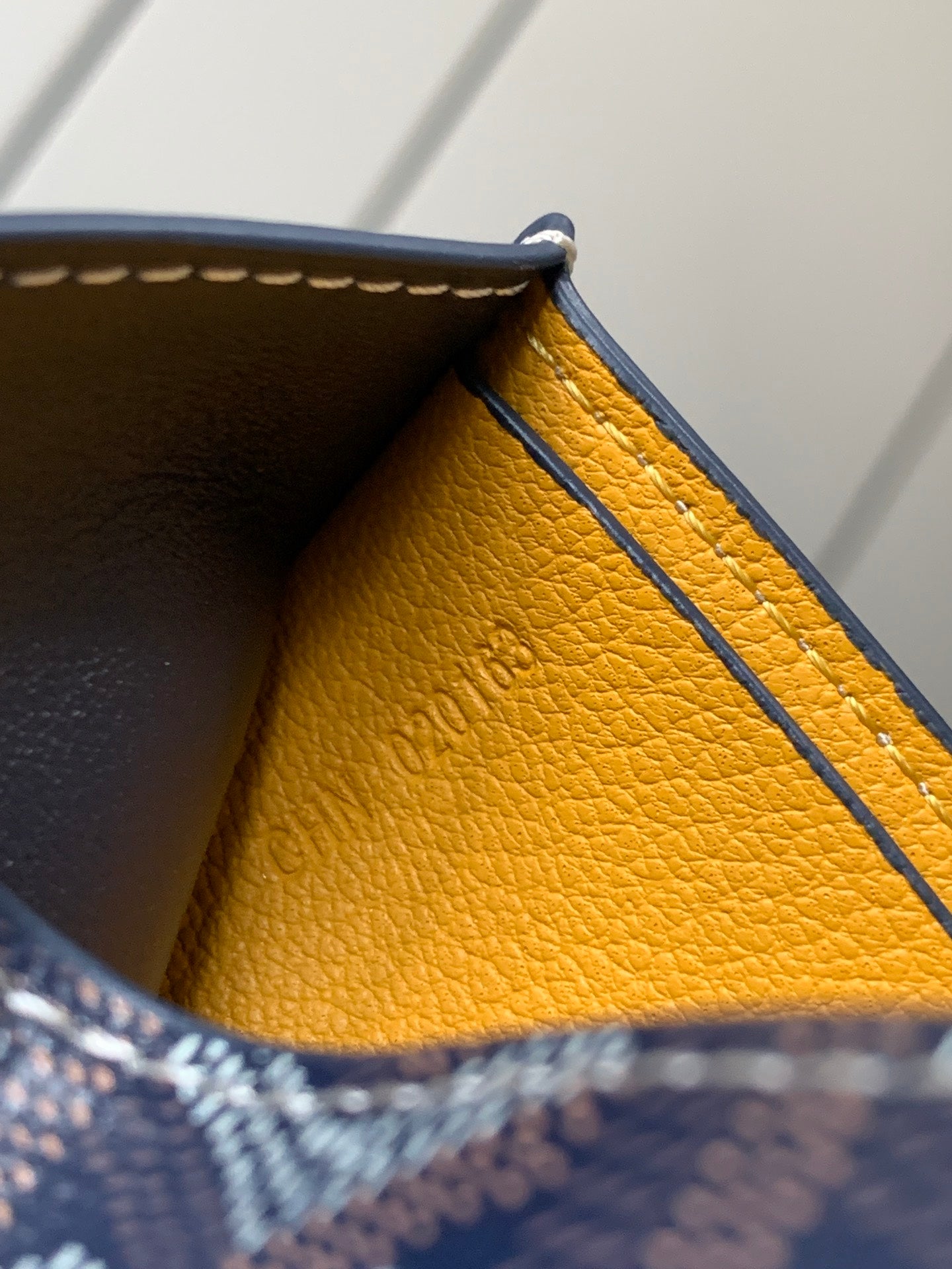 Small bag interior with textured yellow lining and navy edge trim