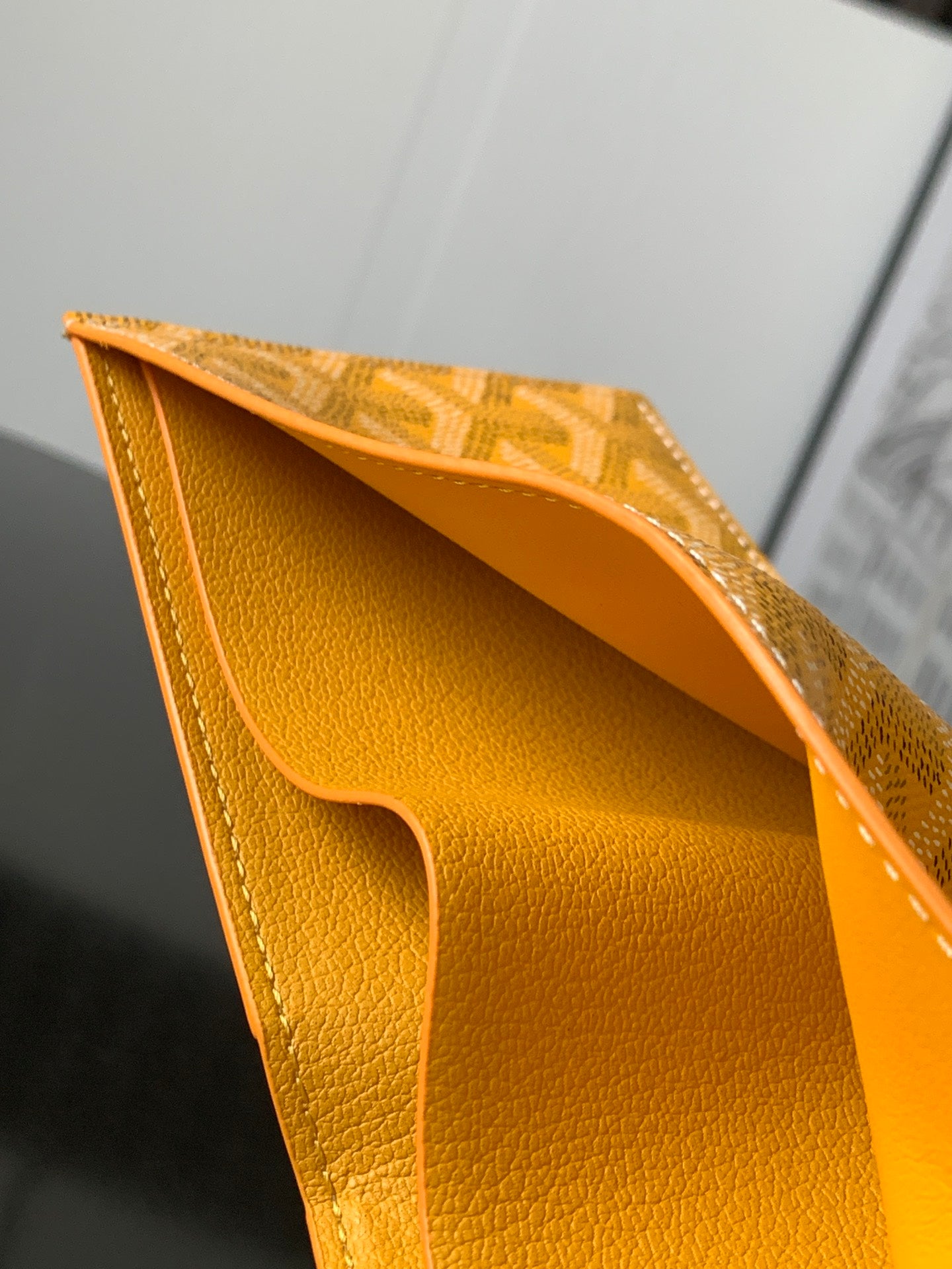 Goyard small bag, open top revealing smooth yellow leather interior