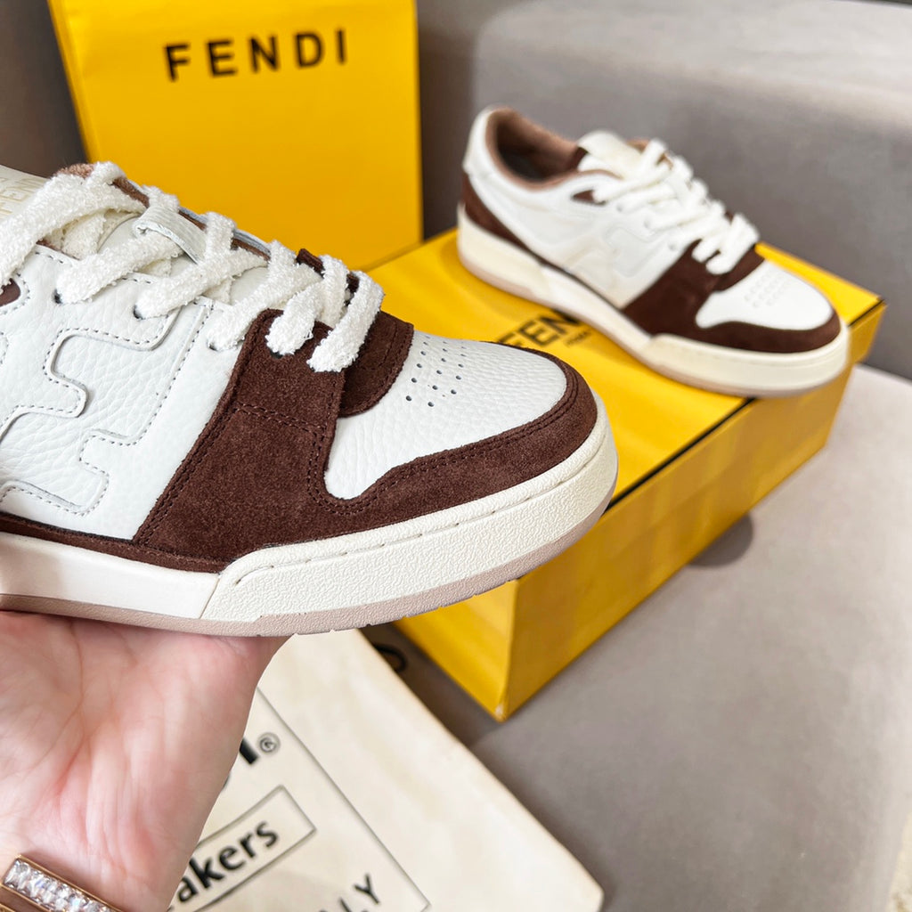 Unisex Fendi sneakers close-up, white leather with dark brown swoosh-style side panel