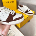Unisex Fendi sneakers close-up, white leather with dark brown swoosh-style side panel