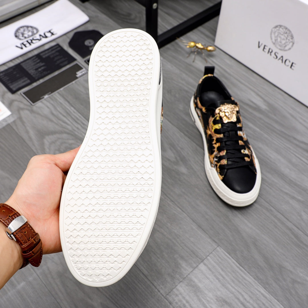 White outsole of black-and-gold sneakers shown in hand