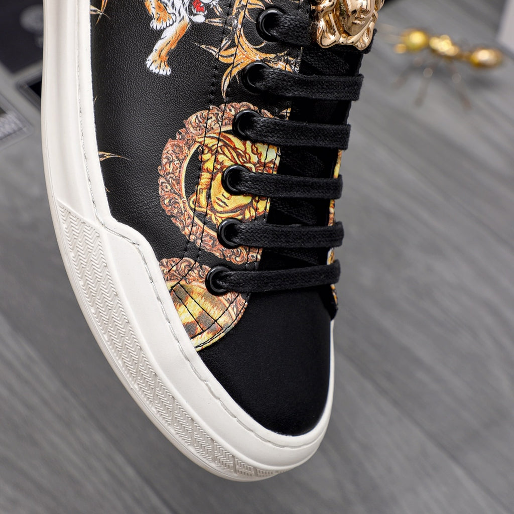 Close-up of black sneaker laces and gold animal print detail