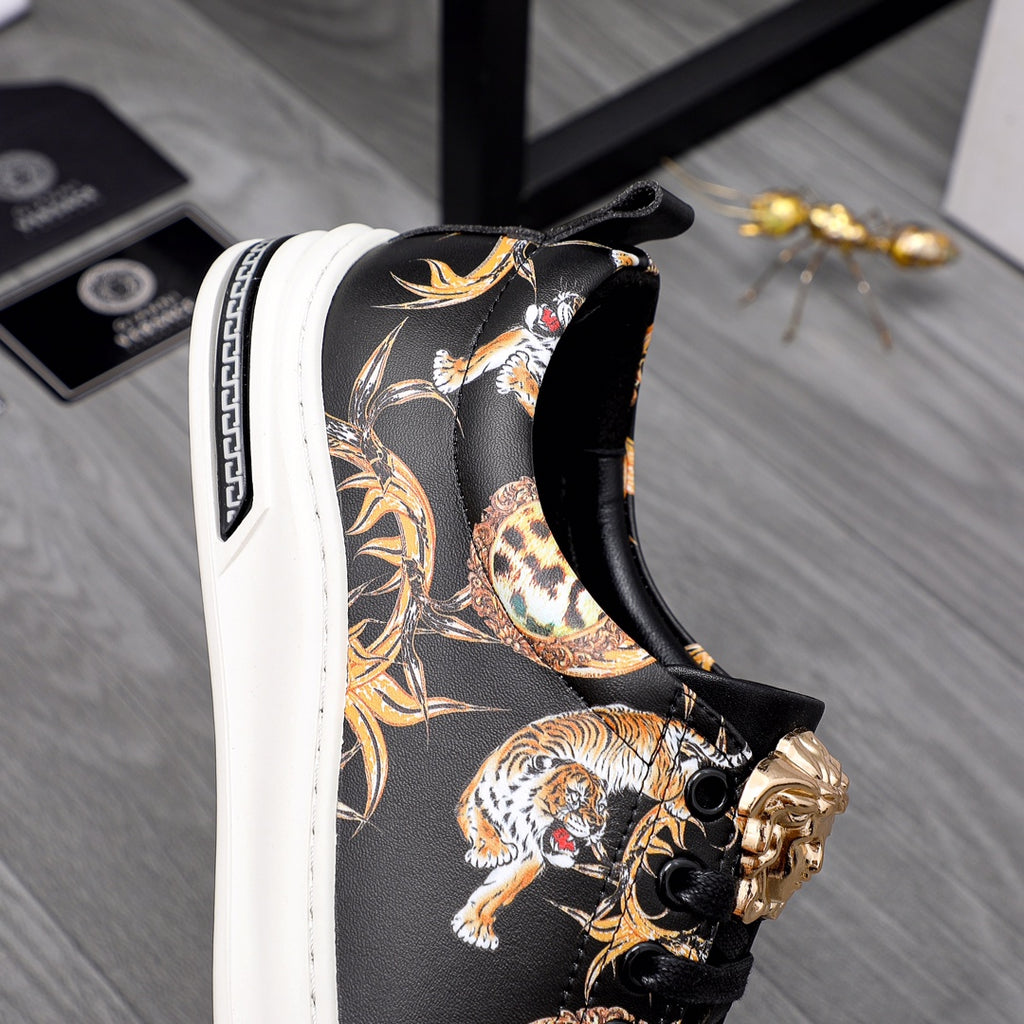 Side view black sneaker with gold animal artwork and gold-toned ornament on strap