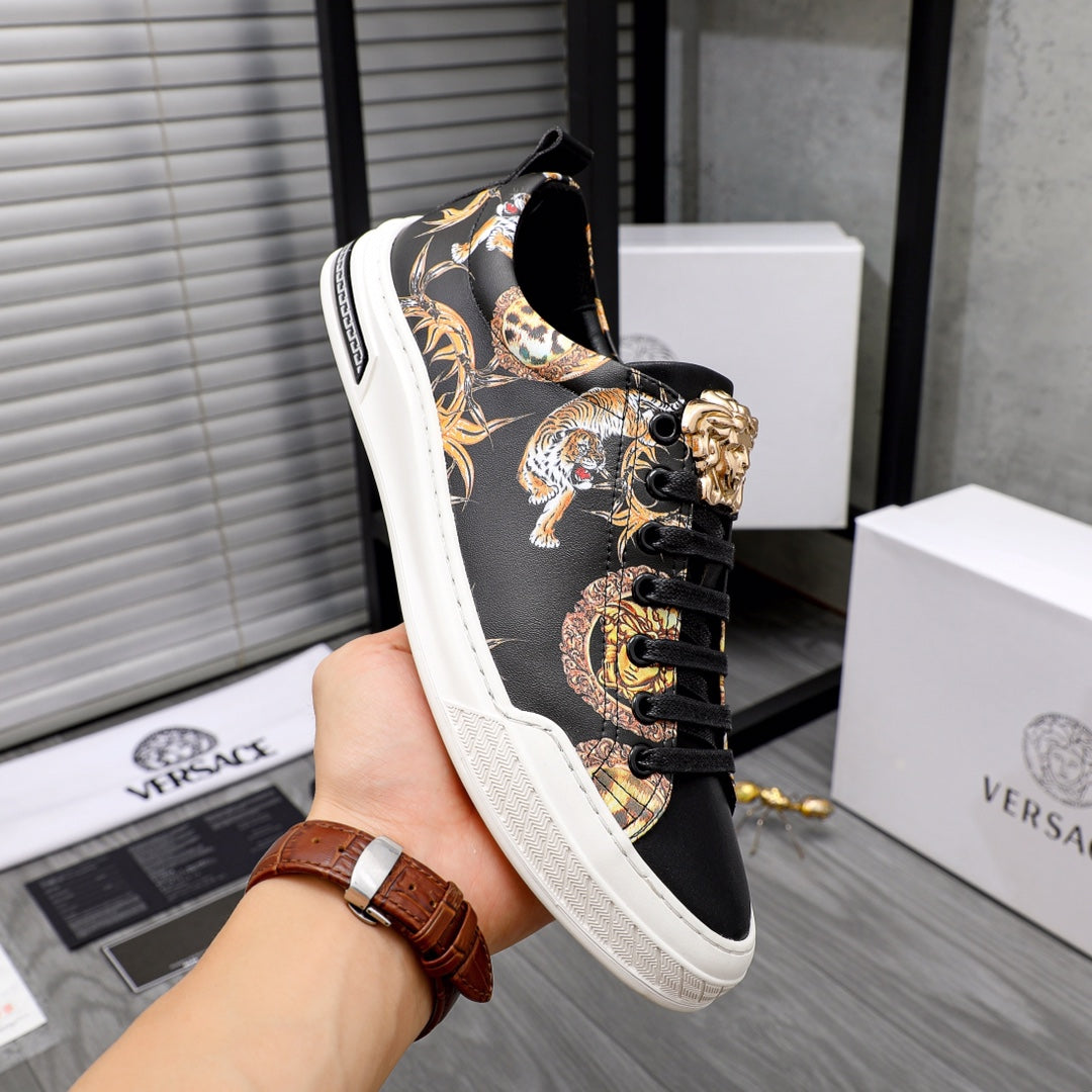 Black sneaker on hand, gold and animal graphic embroidery, lace-up with eyelets