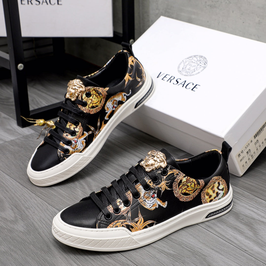 Black low-top sneakers with gold animal print panels and lace-up front