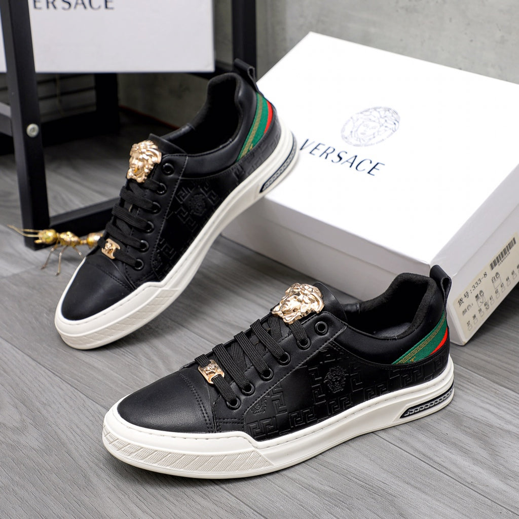 Versace black low-top sneakers with gold crest hardware, green/red stripe, and white sole