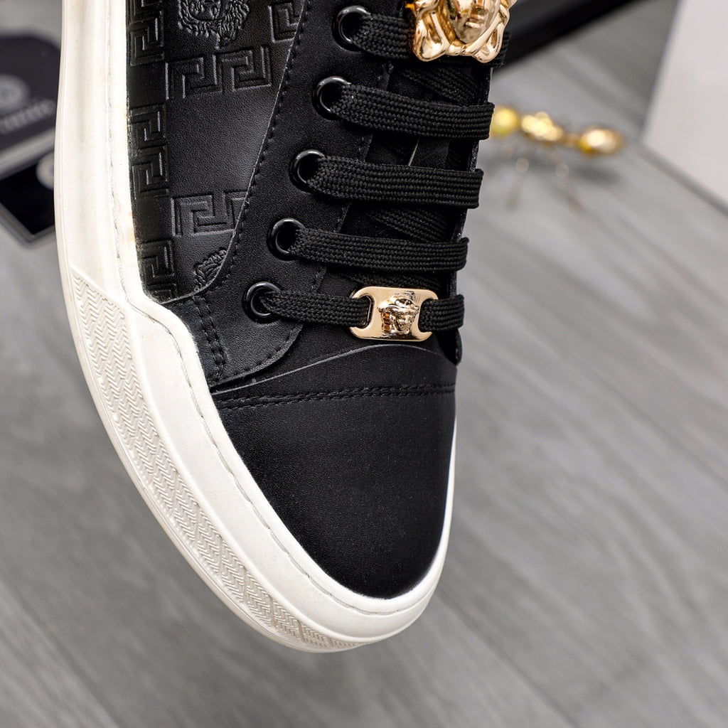 Versace black low-top sneaker close-up, black laces and gold crest lace hardware