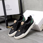 Versace black low-top sneakers pair, gold crest details, green/red stripe, white rubber sole