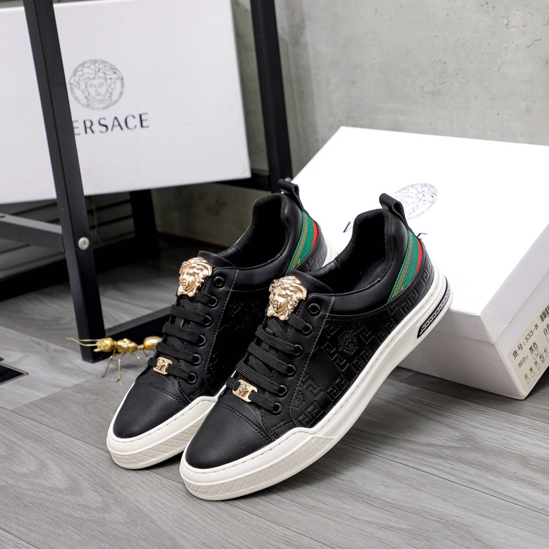 Versace black low-top sneakers pair, gold crest details, green/red stripe, white rubber sole