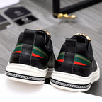 Versace black low-top sneakers heel view, green/red stripe bands and gold crest detail