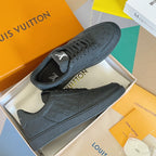 Louis Vuitton dark embossed monogram low-top sneakers with lace-up closure.