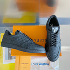 Louis Vuitton embossed monogram low-top sneakers, dark leather, lace-up design.