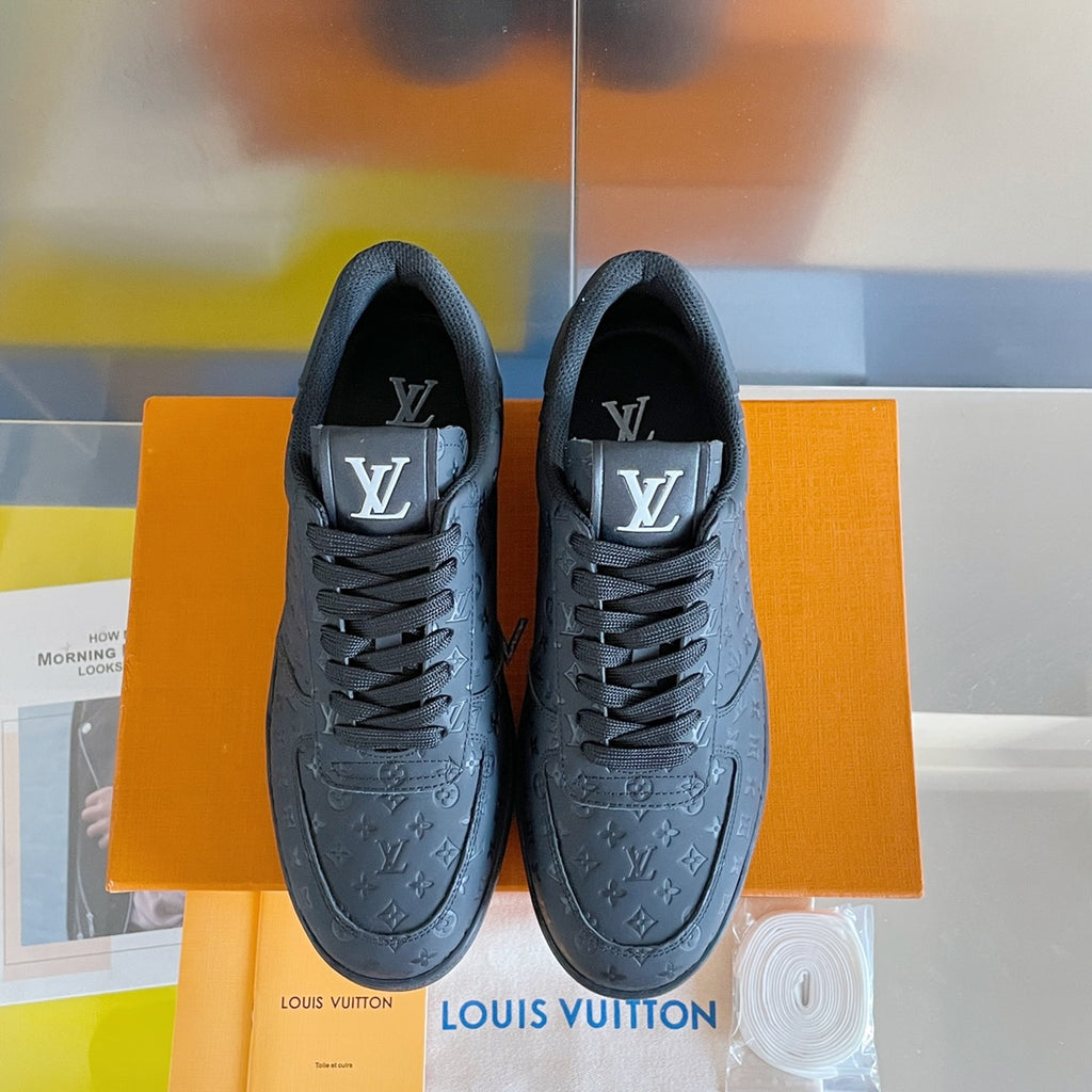 Louis Vuitton dark monogram low-top sneakers, front view with lace-up laces.