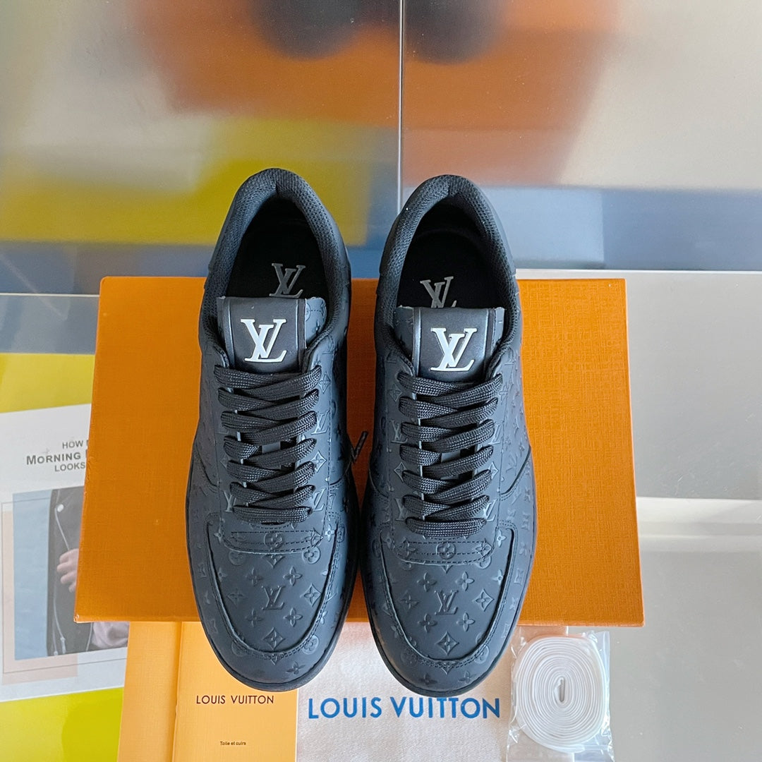 Louis Vuitton dark monogram low-top sneakers, front view with lace-up laces.