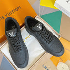 Louis Vuitton low-top lace-up sneakers with dark embossed monogram pattern.