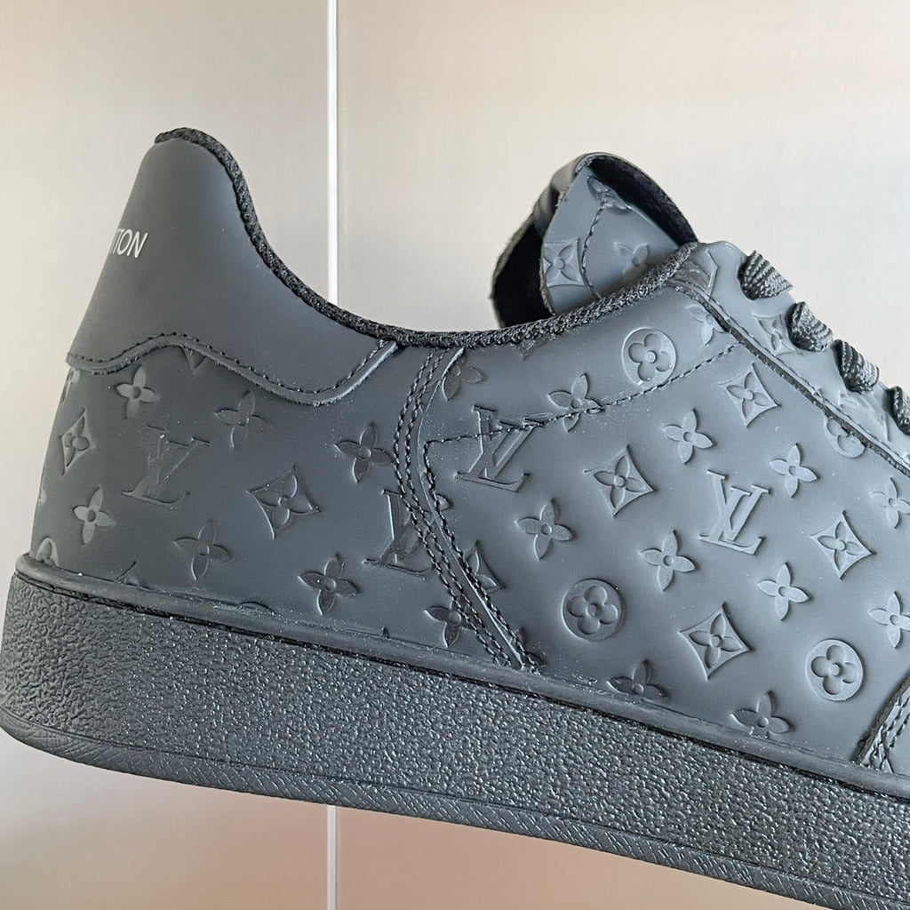 Louis Vuitton dark embossed monogram low-top sneaker upper with lace eyelets.