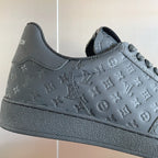 Louis Vuitton dark embossed monogram low-top sneaker upper with lace eyelets.