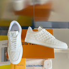 White embossed LV monogram lace-up sneakers with signature tongue logo, angled view.